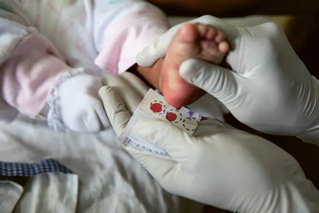 Taking blood samples from a baby.
