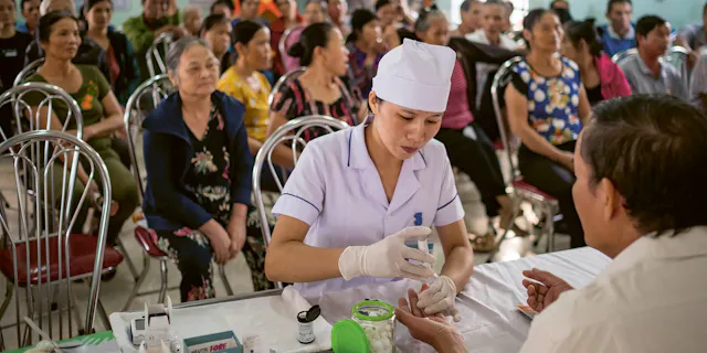 Novartis x Monocle article cover showing a healthcare worker with a patient, referencing Marc Boutin and Laura McKeaveney's discussion on patient engagement
