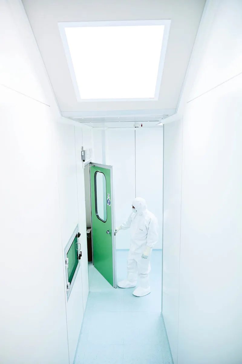 Employee enters the laboratory of the company Advanced Accelerator Applications in a protective suit.