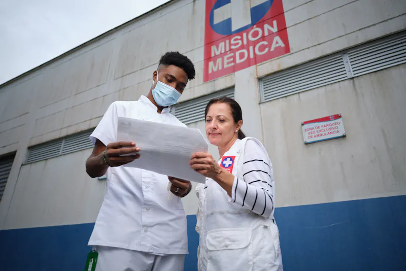 Alexandra says that partnerships between pharmaceutical companies, research centers, public health organizations and local communities are critical to develop new treatments and address the impact of neglected tropical diseases.   Photo: Alexandra works with local healthcare professionals like Eyder Cuesta (left), pictured outside a clinic in Santa Cecilia, Colombia.