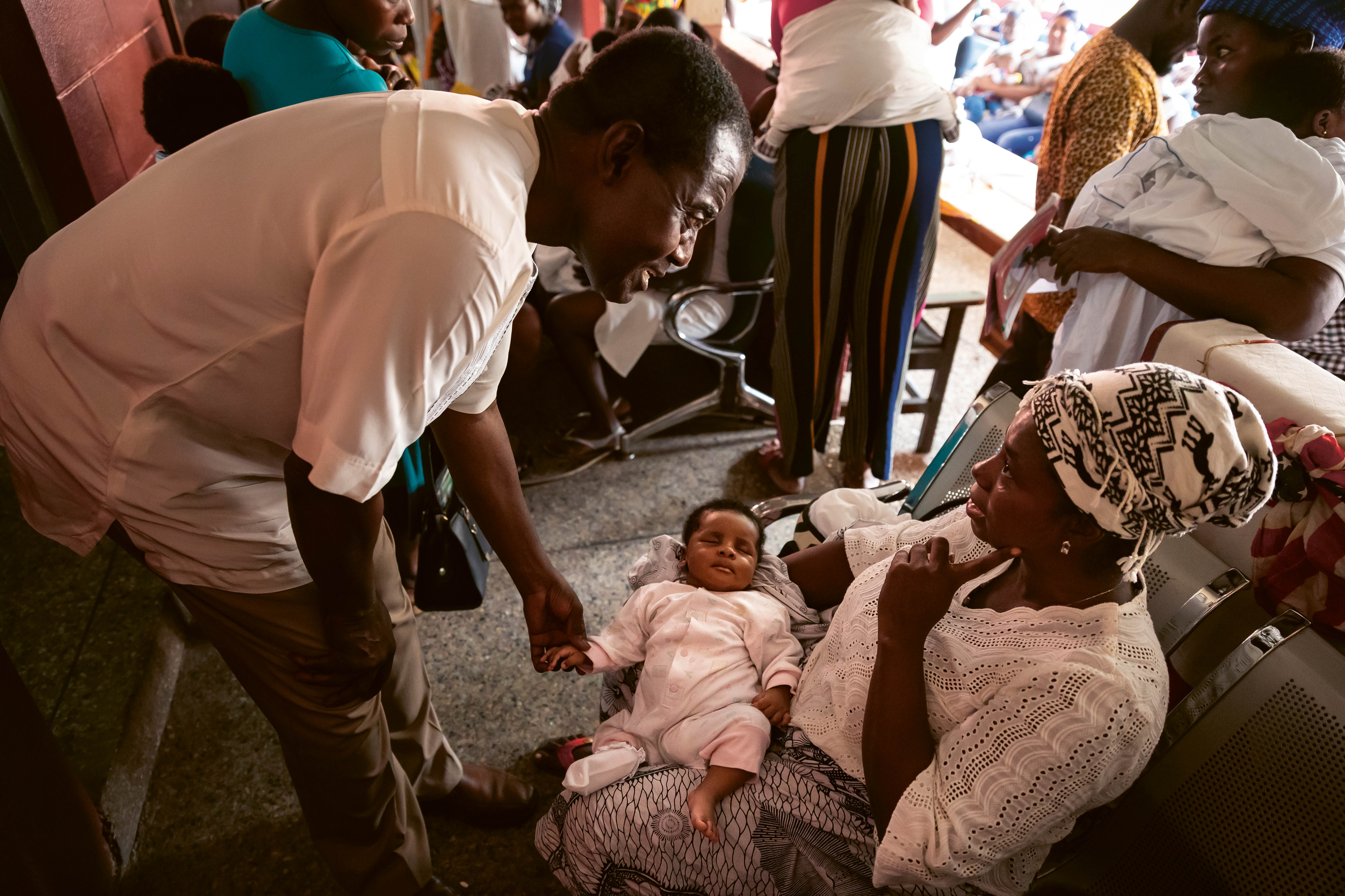Dr. Kwaku Ohene-Frempong examining a baby in a doctor's office practice in Ghana. 