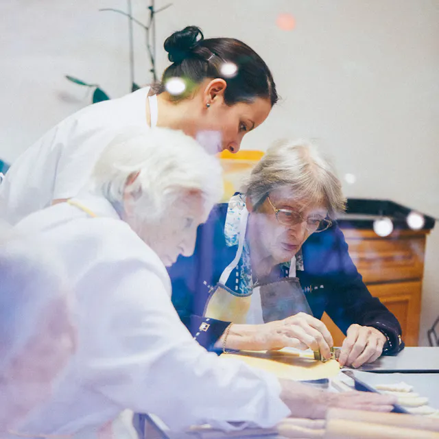 Ruth Lindemann (right) and the other residents of the garden ward baking cookies together at Christmas.