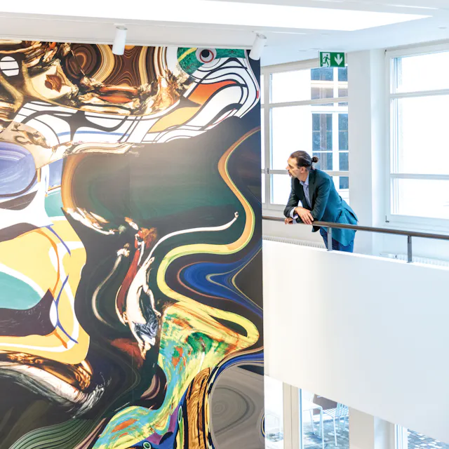 Daniel Canogar standing in front of one of his works at Galerie Wilde in Basel.