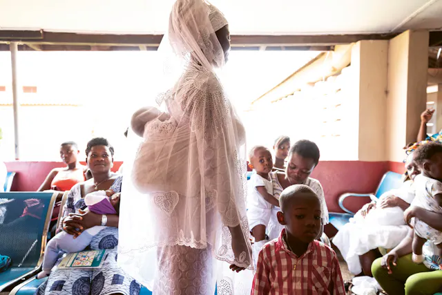 Mothers and children in a waiting room in Ghana.