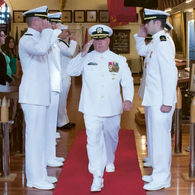 James Goudreau saluting during his retirement ceremony at the US navy.