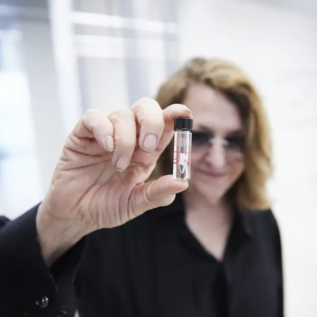 One of the most respected media artists of our time, Lynn Hershman has been working on the confluence of art and science since the 1970s. She is holding the vial with the antibody that carries her name.