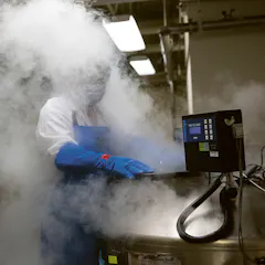 A researcher retrieves stored cells from the liquid nitrogen storage at the Novartis campus in Emeryville, California.