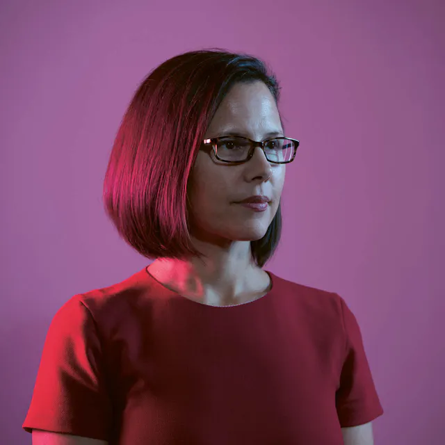 Mimi Huizinga, former VP, Strategic Data Head, now Head of US Oncology Medical in front of red background. 