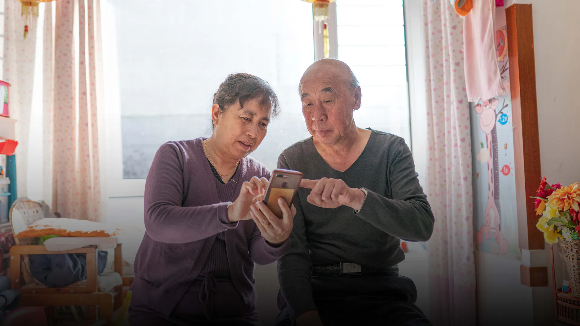 Jian Zhang and his wife check the AI Nurse app at home in Shenyang, China. Mr. Zhang is one of approximately 300 000 people in China using the AI Nurse digital health app.