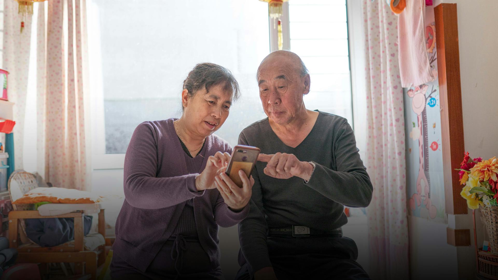 Jian Zhang and his wife check the AI Nurse app at home in Shenyang, China. Mr. Zhang is one of approximately 300 000 people in China using the AI Nurse digital health app.