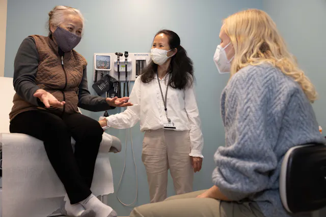 Tammy Ly (center), a Jefferson community health worker, provides language interpretation at a health center, where she helps bridge different cultural traditions that could affect health and supports immigrant residents to access information about health services. Born in Vietnam, Tammy moved to Philadelphia in 1988 and has worked as a medical interpreter for more than 20 years.
