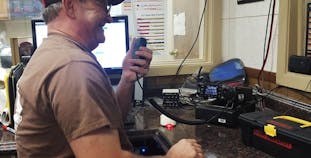 Michael Bentley from Texas smiles and talks on a CB radio.