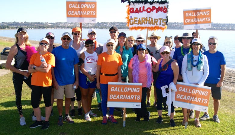 A group of people with "Galloping Gearharts" signs at the Team NPF Walk.