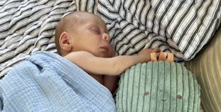Jocelyn Hall's baby cuddles up to a stuffed toy.