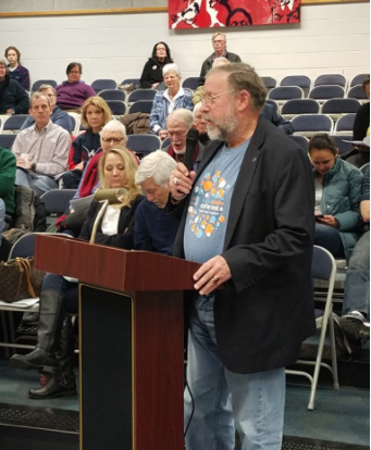 NPF advocate Stephen from Virginia, speaking at a podium in a public forum.