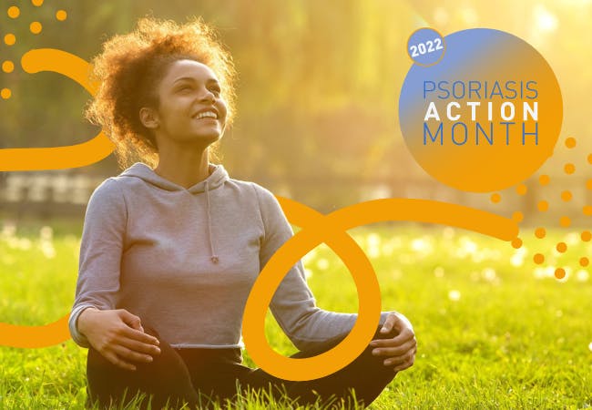 A woman with an afro sits cross legged on the grass in a field and looks up smiling, Graphic for Psoriasis Action Month 2022 overlaid.
