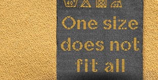 Treatment one size does not fit all clothes tag.