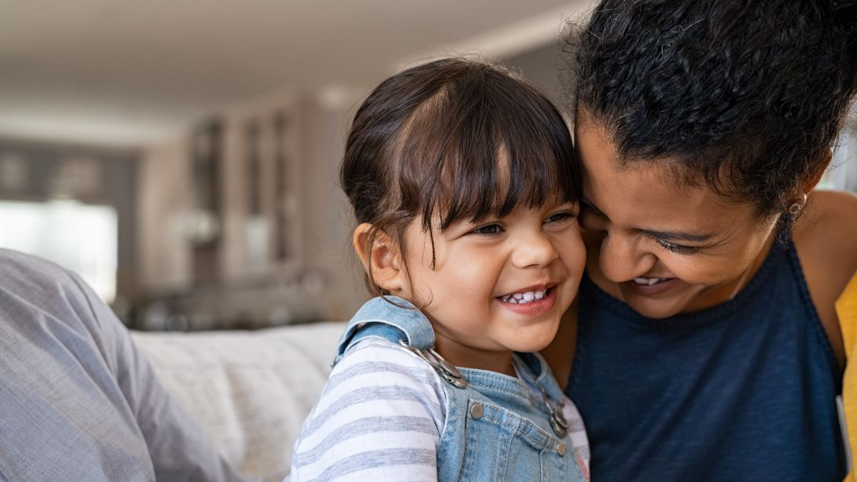 Mom and daughter smiling.