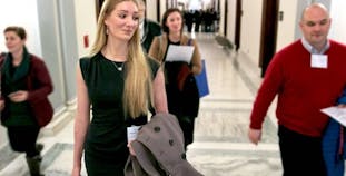 Woman walking with work bag.