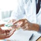 A doctor shows a patient medication in a professional office.