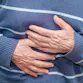 Person holding their gut with their hands.