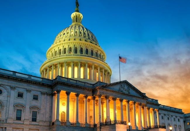 An image of the US Capitol Building in the evening.