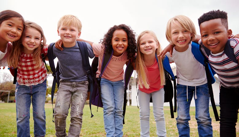 Children huddled in a group smiling