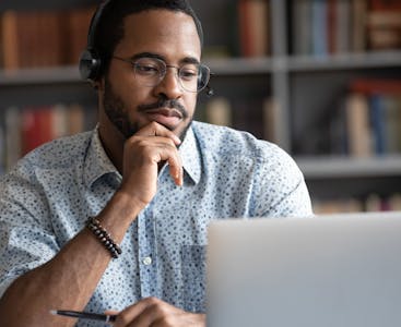 A young doctor attends a virtual dermatology conference.