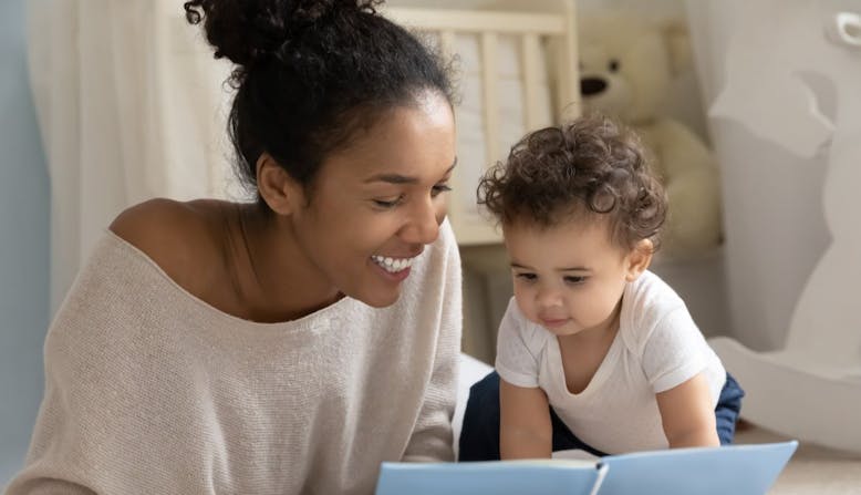 Mother and son look at a book.