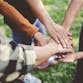 Several hands together in the center.