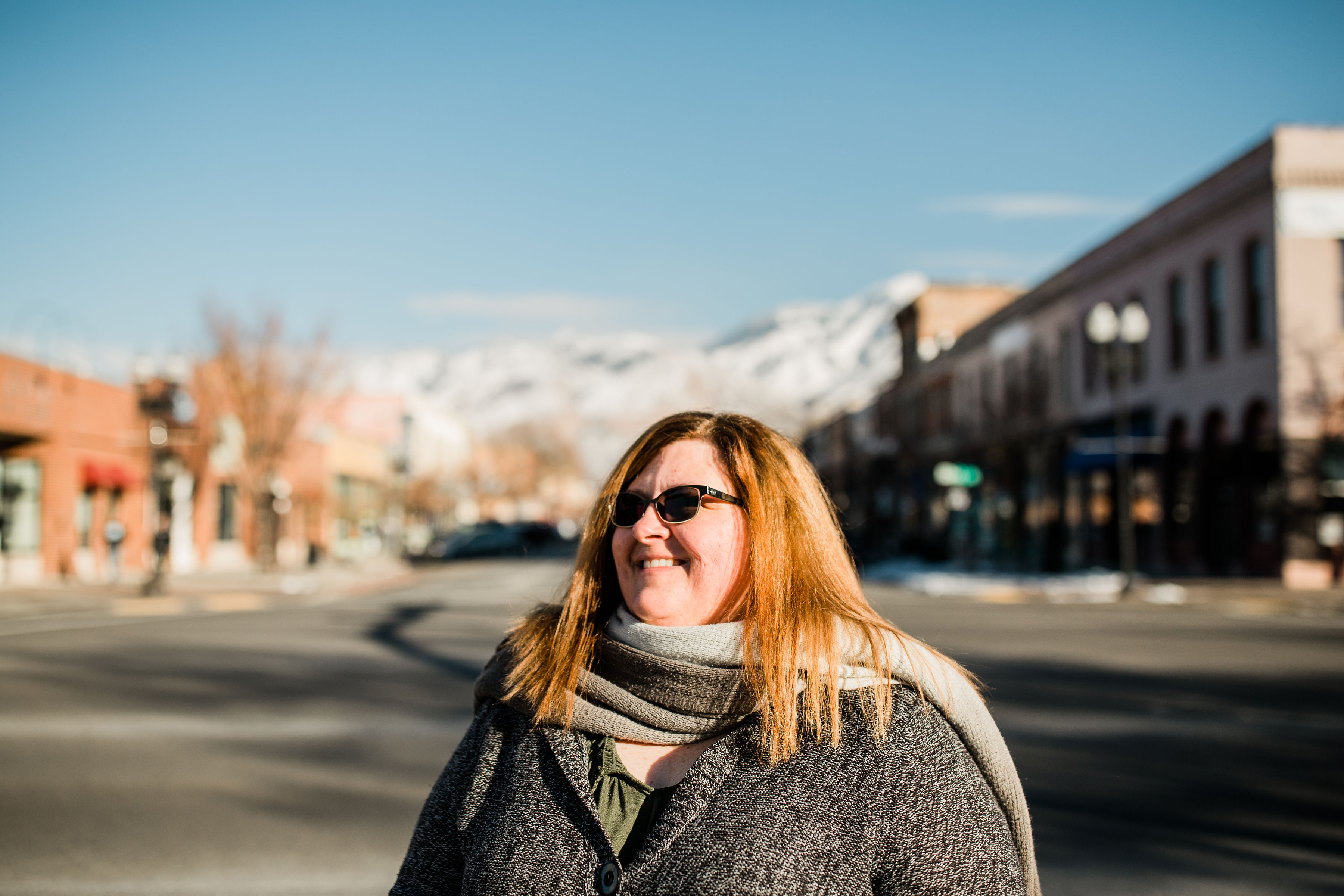 Lisa standing outside buildings. 