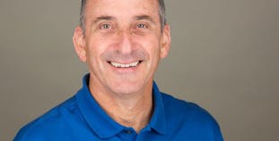 Hillel Katzeff smiling and wearing a blue shirt.