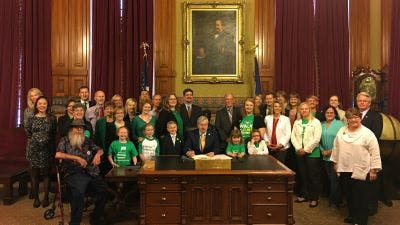 NPF advocates gather in Iowa's capitol for a bill signing ceremony. 