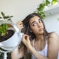 A nervous girl running her fingers through her hair and thinking about about dandruff and hair loss.