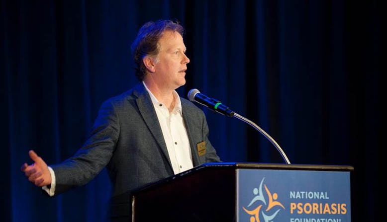 NPF volunteer Matt Kiselica speaks at a podium at an NPF event.