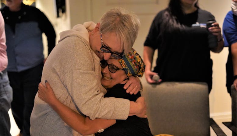 Cat Kiselica and Tami Seretti embracing. Attendees from the Community Conference - Healthier Together: Learning for All Ages. 