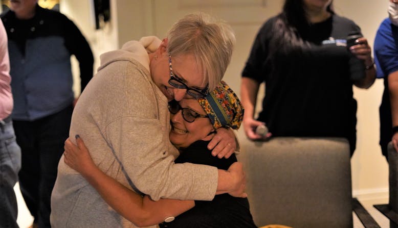 Cat Kiselica and Tami Seretti embracing. Attendees from the Community Conference - Healthier Together: Learning for All Ages.