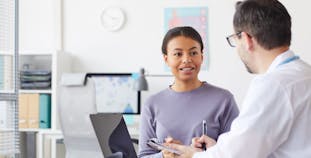 A woman and researcher talk about research.