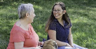 Nora Yechou and Julie Greenwood share time together outside.