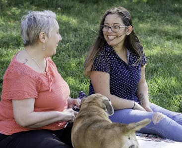 Nora Yechou and Julie Greenwood share time together outside.