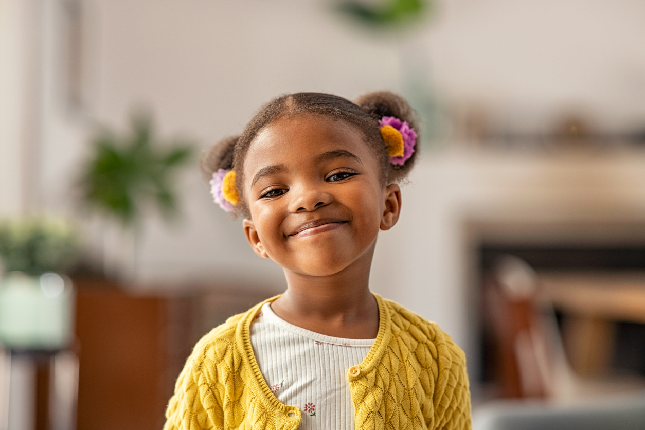 A child smiles at the camera.