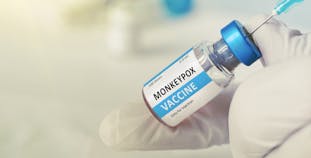 A needle pierces a vial of monkeypox vaccine.