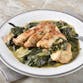 A dish of chicken piccata with spinach.