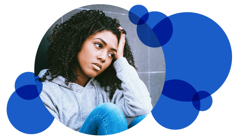 A young woman looking anxious or depressed. Surrounded by blue bubbles.