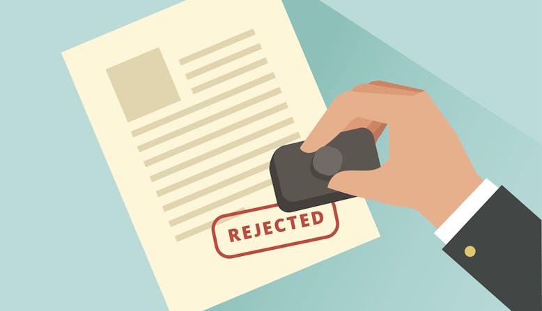 Graphic of a person holding a stamp over a paper that says "Rejected" in red.