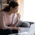A woman talks to her One to One mentor or mentee on a laptop.