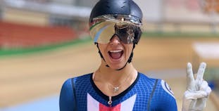 Professional cyclist Mandy Marquardt smiles and waves.