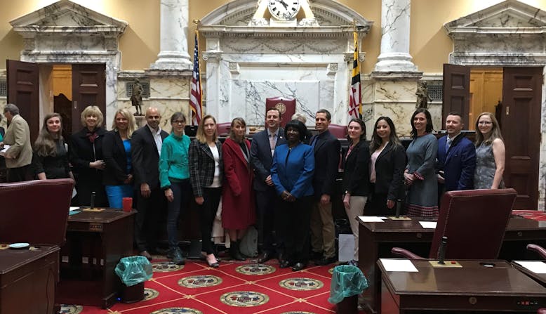 Advocates standing together in a legislative building.