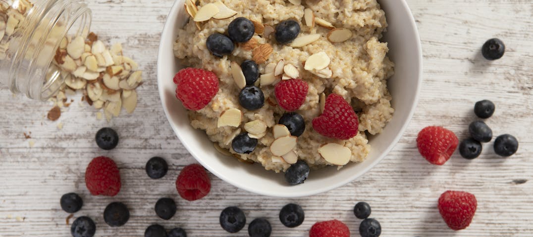 A bowl of granola, fruit and nuts.
