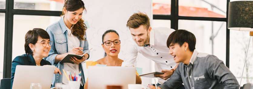Group of people collaborating on a project in an office.